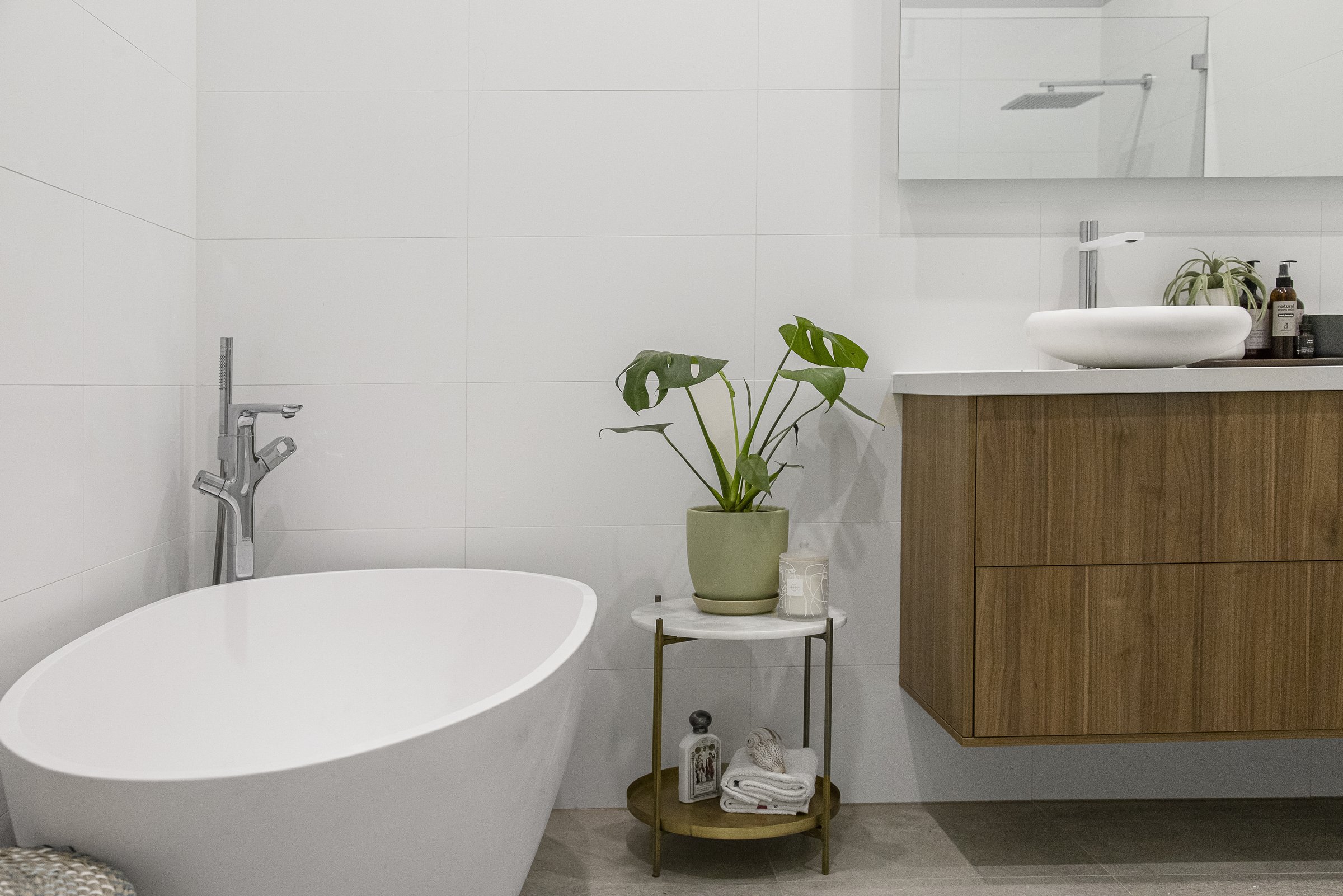 Minimalist bathroom with a freestanding bath and timber vanity