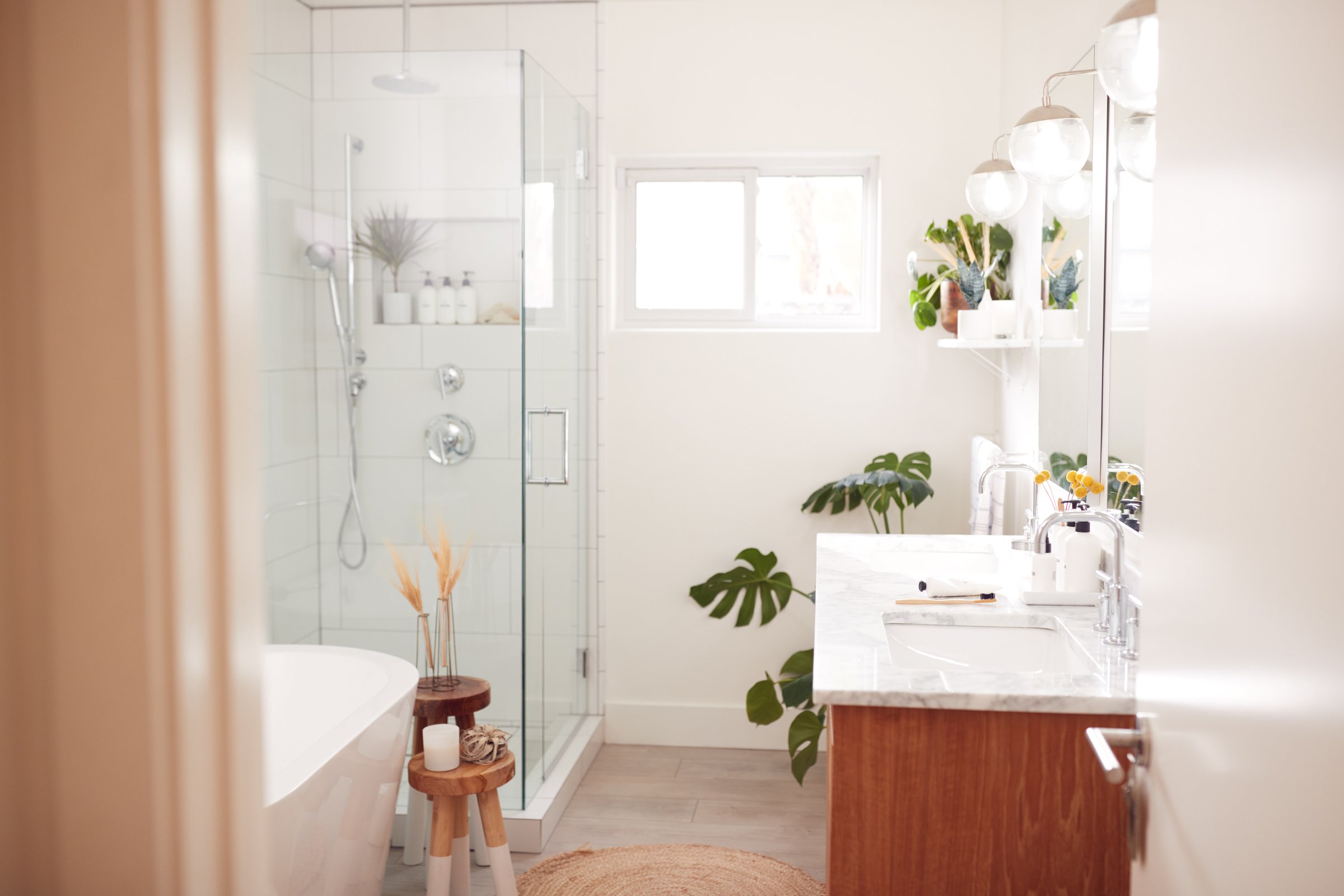 Bright bathroom with white marble and a glass shower