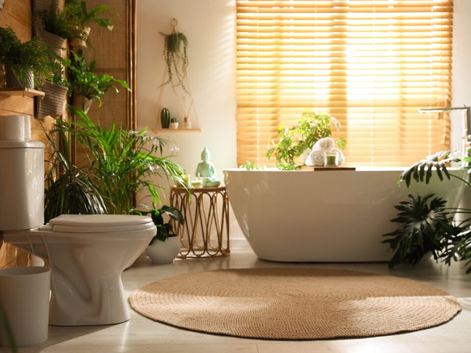 Bathroom with a freestanding bath surrounded by plants
