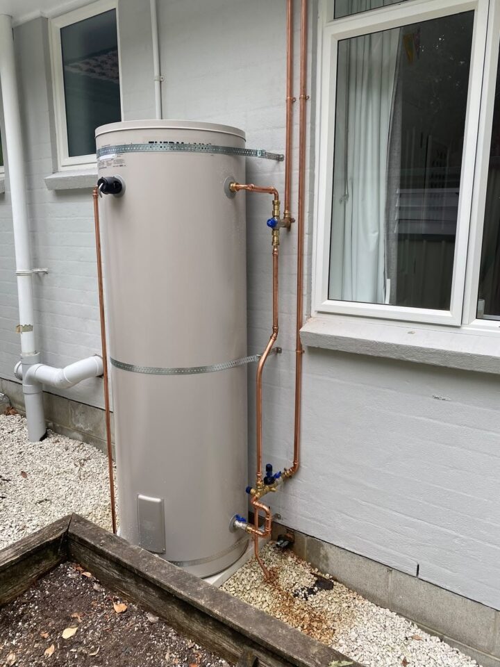 Hot water cylinder installed on an exterior wall