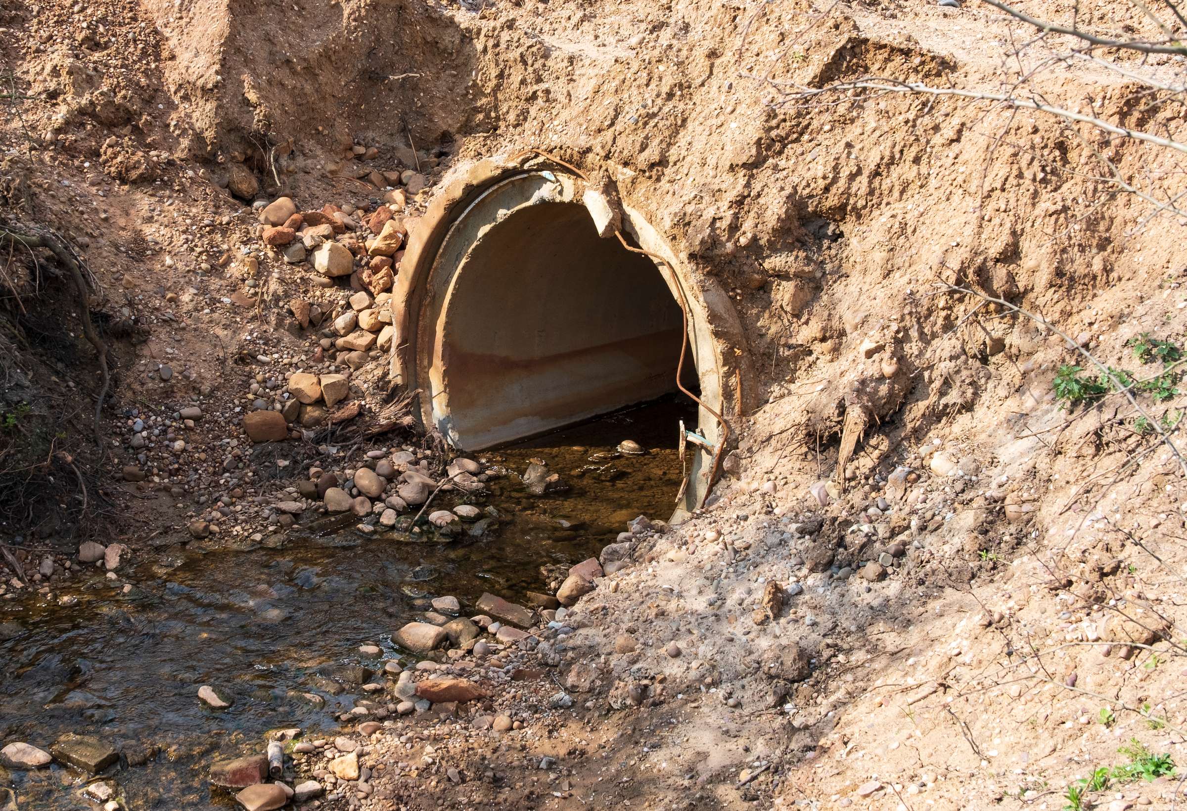Water running through a rural culvert