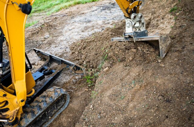 Excavator working on rural ground