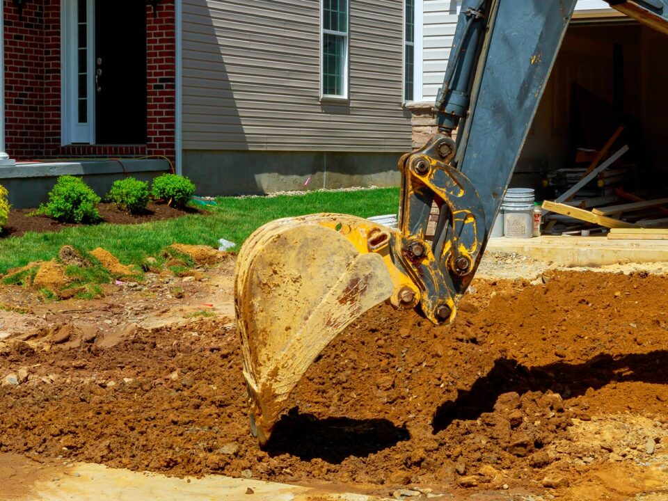 Excavator working on a suburban construction site