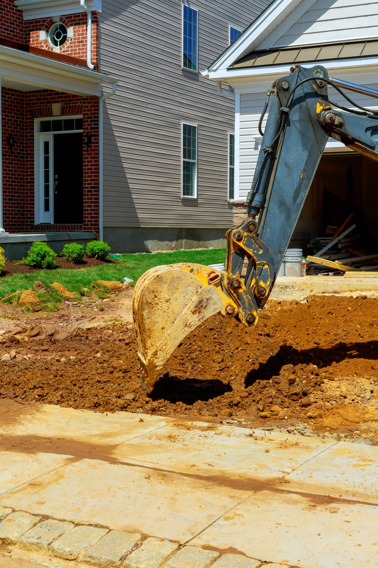 Excavator working on a suburban construction site