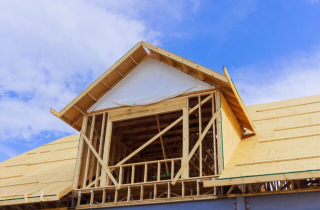 New house under construction with timber framing