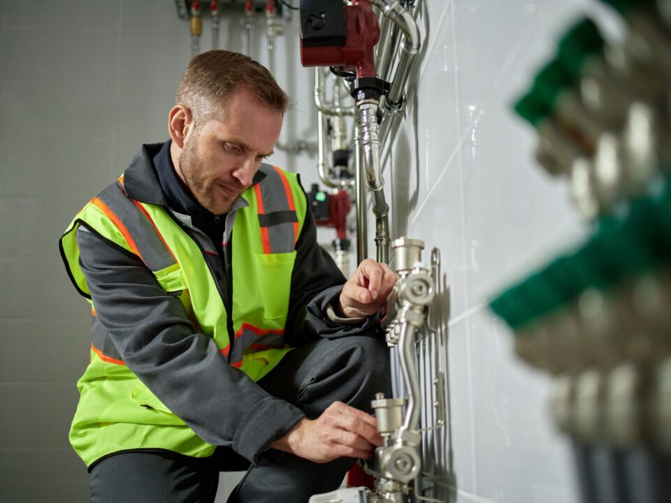 Technician working on pipework in an industrial building