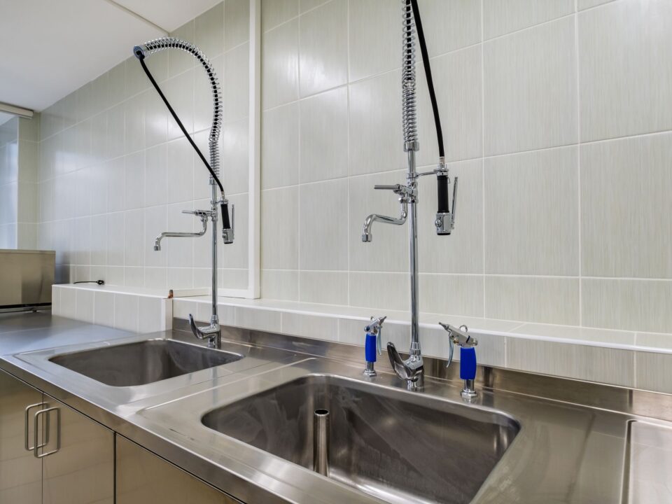 Stainless steel sinks and benches in a commercial kitchen
