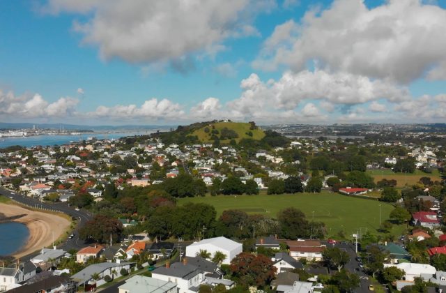 Aerial view over Auckland villas and bungalows toward the harbour